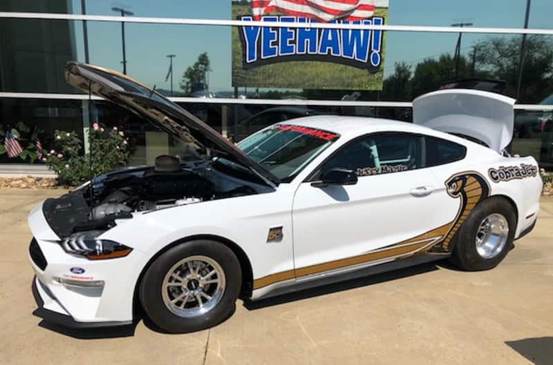 Super Cobra Jet Mustang in front of Ford Dealership